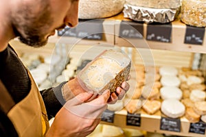 Holding a blue cheese at the store