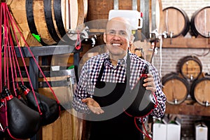 Seller holding spanish bota bag for wine photo