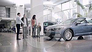 Seller meets family in a car showroom