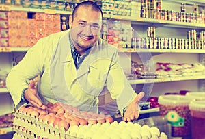 Seller posing with dozens of eggs