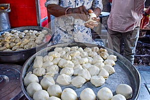 Seller preparing Traditional Cardamom Kachori, street food in markets and bazaar