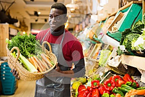 Seller proffering carrots and celery