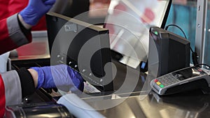 the seller scans the goods at the checkout in the supermarket. close up of female hands scanning barcode of meat