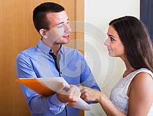 Seller showing documents indoors