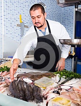 Seller showing fish lying