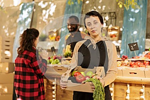 Seller shows box of organic eco produce