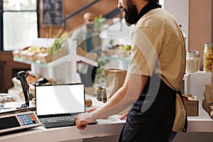 Seller using laptop with white screen