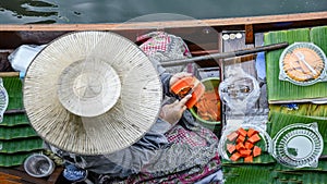 Seller woman with a boat in Thailand Floating Market Damnoen Saduak near Bangkok, Bangkok, Thailand