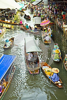 Selling food on a boat at floating market, Thailand