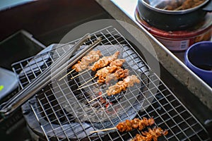 Selling Grilled crocodile Stick shop on the boat in Pattaya Floating Market in Chonburi City Thailand