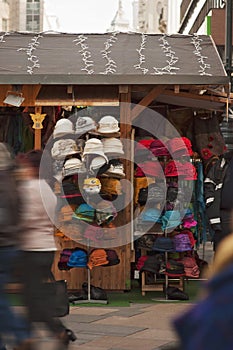 Selling many different colored hats in Christmas market in Budapest, Hungary Europe. Many people and tourists shopping for
