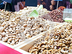 Selling nuts. Assortment of different salted and sweet organic nuts. Selling nuts in outdoor marke