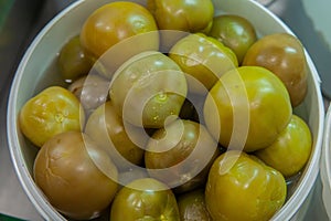 Selling salted green tomatoes at the vegetable market