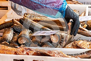 Selling various smoked fish in a street food market