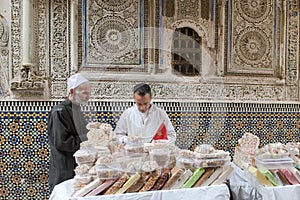 Selling white nougat in front of a mosque, Fez, Morocco