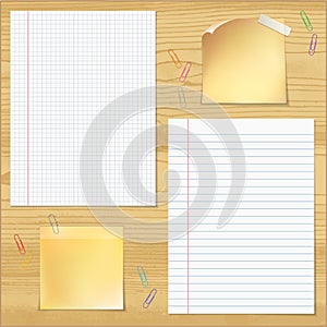Sells and strips notebook paper with paper clips on wood table b