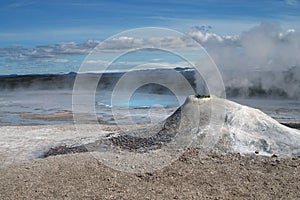 Seltun / Krysuvik KrÃ½suvÃ­k: Mini volcano like fumarole emit sulphuric gas with steaming hot blue natural pool on field