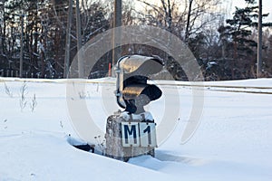 Semaphore on the rails under the snow