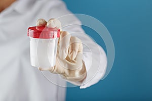 Semen analysis in a Bank is held in the hand of a doctor. Infertility