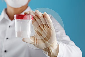Semen analysis in a Bank is held in the hand of a doctor. Infertility