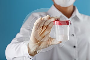 Semen analysis in a Bank is held in the hand of a doctor. Infertility