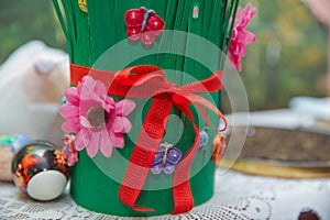 Semeni on vintage plate decorated with red cord on national style table cloth . Red ribbon connected Semeni . Green Paper made