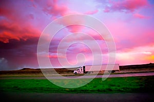 Semi 18 Wheel Diesel truck at sunset with storm