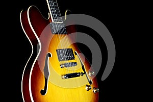 Semi Acoustic Electric Guitar Isolated Against a Black Background