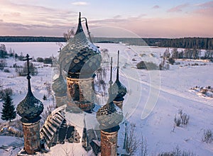 Semi-destroyed dome crosses of the abandoned church in the Yaroslav region in winter, Russia