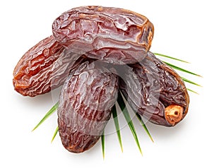 Semi-dried dates or date palm fruits lie on palm leaves isolated on white background. File contains clipping path photo