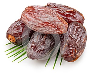 Semi-dried dates or date palm fruits lie on palm leaves isolated on white background. File contains clipping path photo