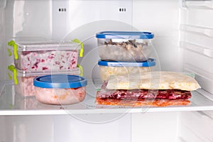 Semi-finished products. Frozen food in the refrigerator. Vegetables on the freezer shelves