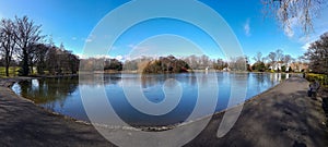 Semi-frozen pond at Lease Park in Newcastle, UK on an early spring sunny but cold day