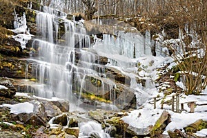 Semi frozen waterfall Tupavica and moss covered rocks