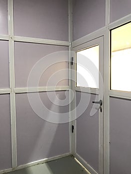 Semi glazed door and panels made of aluminum for an warehouse office installed on a concrete floors