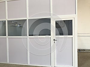 Semi glazed door and panels made of aluminum for an warehouse office installed on a concrete floors