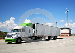 A Semi with Green Highlights and Wind Turbine