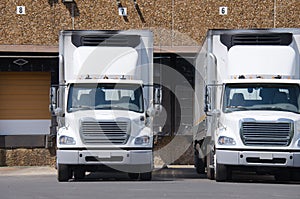 Semi tractor trailer trucks at a loading dock