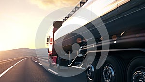 Semi-trailer tank truck driving along a desert road into the sunset