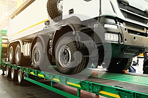 Semi-trailer transports a lorry. Transporting a heavy truck by semitrailer