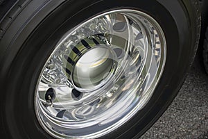 Semi-trailer truck detal metal chrome close up of a wheel on tramac