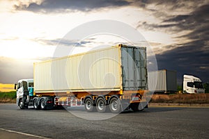 Semi Trailer Truck Driving on Highway Road with The Sunset. Freight Trucks Logistics Cargo Transport.