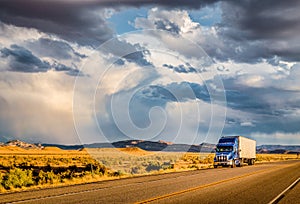 Semi trailer truck on highway at sunset