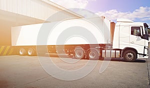 Semi Trailer Trucks a Parking at The Warehouse. Industry Road Freight Truck. Logistic and Cargo Transport Concept.