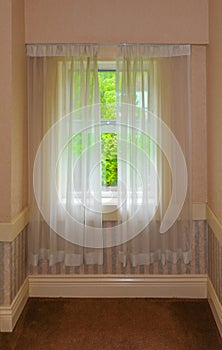 Semi transparent valance on a window in a house.