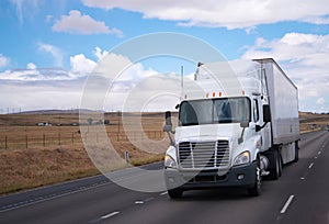 Semi truck big rig on road with meadow background