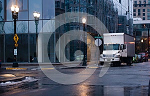Semi truck with box trailer in night rainy city street