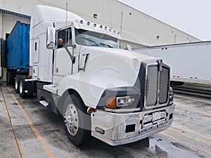 Semi truck cab white blue trailer