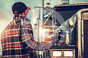 Semi Truck Driver Getting Ready For His Job Finishing His Cup of Coffee