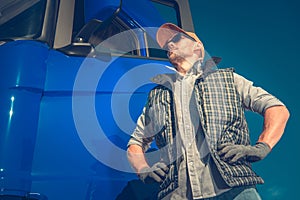 Semi Truck Driver Outside Of Vehicle Cab Observing Road
